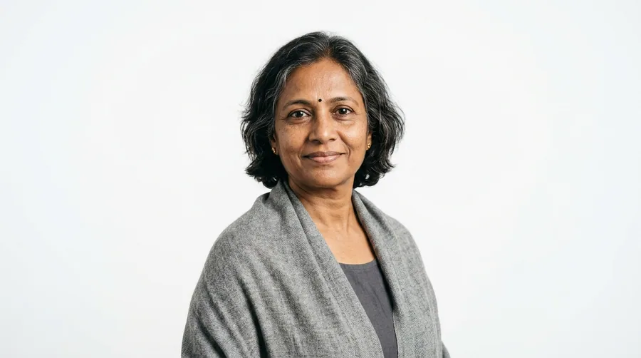 Portrait of a woman in her fifties with full hair and natural greys, wearing a shawl